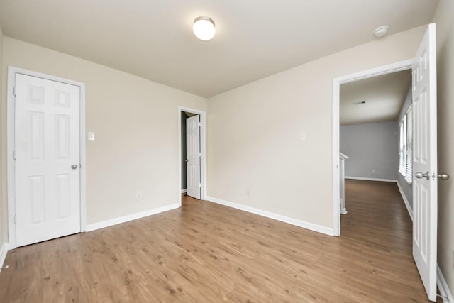 9914 Swallow Dr, Conroe, TX 77385 - empty room featuring wood finished floors and a smoke detector