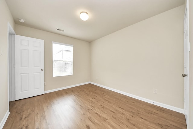 9914 Swallow Dr, Conroe, TX 77385 - unfurnished bedroom with wood finished floors and baseboards