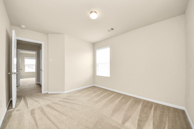 9914 Swallow Dr, Conroe, TX 77385 - spare room featuring light colored carpet and a smoke detector