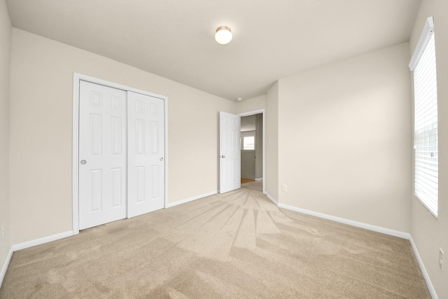 9914 Swallow Dr, Conroe, TX 77385 - unfurnished bedroom with light carpet and a closet
