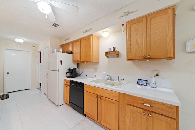 12611 Bexhill Dr, Houston, TX 77065 - kitchen with black dishwasher, freestanding refrigerator, a textured ceiling, a ceiling fan, and tile counters