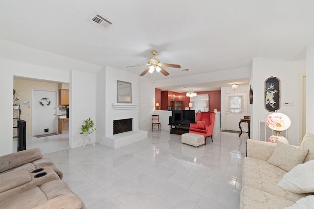 12611 Bexhill Dr, Houston, TX 77065 - living room featuring a fireplace, ceiling fan, light marble finish floors, and a chandelier