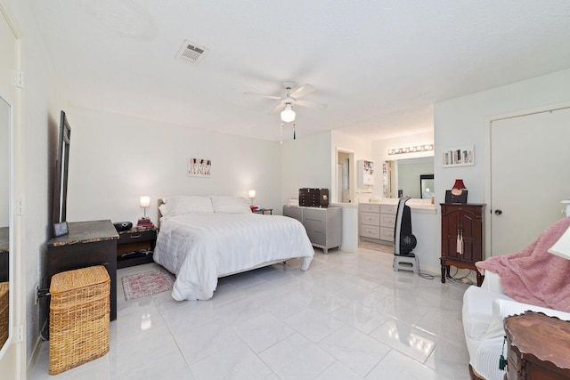 12611 Bexhill Dr, Houston, TX 77065 - bedroom featuring connected bathroom, a ceiling fan, and light marble finish floors