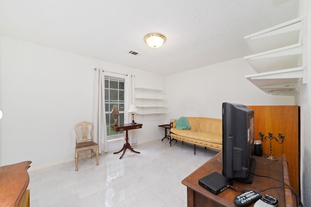 12611 Bexhill Dr, Houston, TX 77065 - sitting room featuring baseboards and a textured ceiling