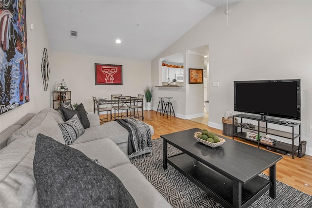 1725 Harvey Mitchell Pkwy S Unit 2234, College Station, TX 77840 - living area with vaulted ceiling, wood finished floors, and recessed lighting