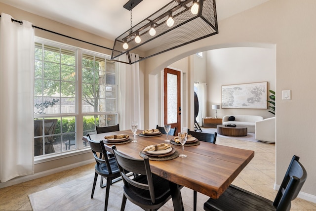 20314 Tarpon Bay Ln, Cypress, TX 77433 - tiled dining area featuring arched walkways and baseboards