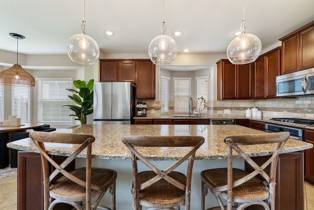 20314 Tarpon Bay Ln, Cypress, TX 77433 - kitchen with stainless steel appliances, backsplash, a center island, recessed lighting, and a kitchen bar