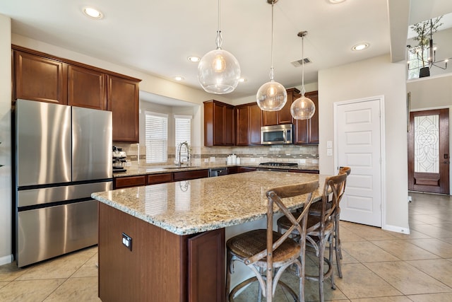 20314 Tarpon Bay Ln, Cypress, TX 77433 - kitchen with appliances with stainless steel finishes, light tile patterned floors, decorative backsplash, light stone counters, and recessed lighting