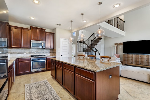 20314 Tarpon Bay Ln, Cypress, TX 77433 - kitchen featuring stainless steel appliances, tasteful backsplash, a kitchen island, light tile patterned floors, and recessed lighting