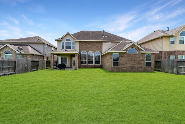 20314 Tarpon Bay Ln, Cypress, TX 77433 - rear view of property with a fenced backyard, a shingled roof, and brick siding