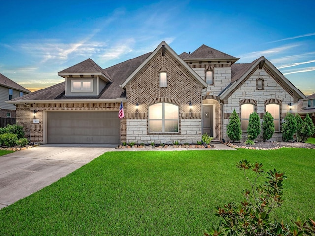 4623 Bisontine Bay Ln, Rosharon, TX 77583 - french country home with brick siding, a lawn, a garage, roof with shingles, and driveway