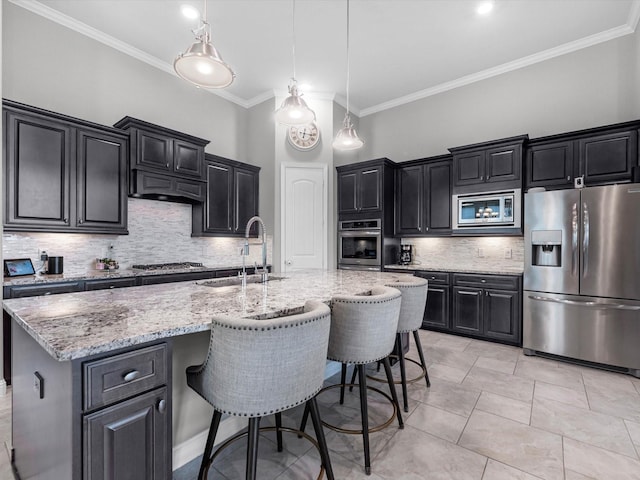4623 Bisontine Bay Ln, Rosharon, TX 77583 - kitchen with stainless steel appliances, dark cabinets, decorative backsplash, ornamental molding, and light stone countertops