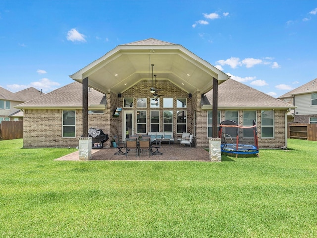 4623 Bisontine Bay Ln, Rosharon, TX 77583 - rear view of property featuring ceiling fan, a patio, brick siding, a trampoline, and roof with shingles