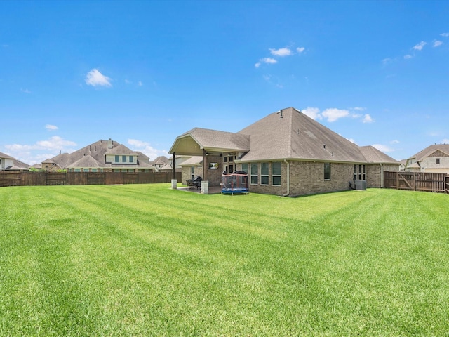 4623 Bisontine Bay Ln, Rosharon, TX 77583 - rear view of property featuring a fenced backyard, brick siding, a shingled roof, and a patio area