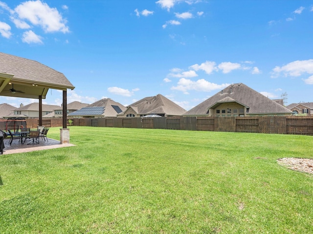 4623 Bisontine Bay Ln, Rosharon, TX 77583 - fenced backyard with a patio area, a ceiling fan, and a residential view
