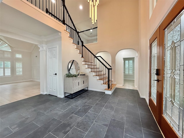 19 Pebble Hollow Ct, The Woodlands, TX 77381 - entrance foyer featuring stairway, arched walkways, and a towering ceiling