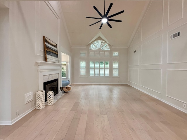 19 Pebble Hollow Ct, The Woodlands, TX 77381 - unfurnished living room featuring crown molding, a fireplace, ceiling fan, light wood-type flooring, and high vaulted ceiling