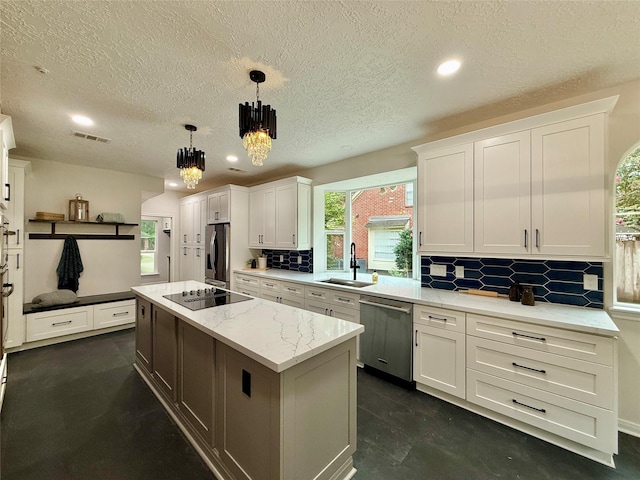 19 Pebble Hollow Ct, The Woodlands, TX 77381 - kitchen with stainless steel appliances, a chandelier, white cabinetry, decorative backsplash, and a textured ceiling