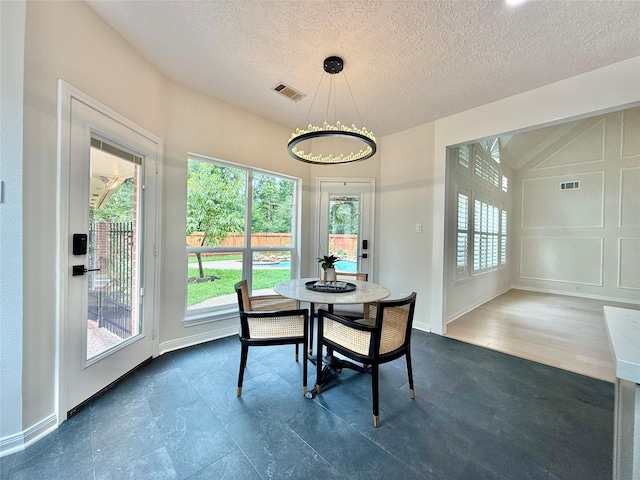19 Pebble Hollow Ct, The Woodlands, TX 77381 - dining room featuring a textured ceiling and a chandelier