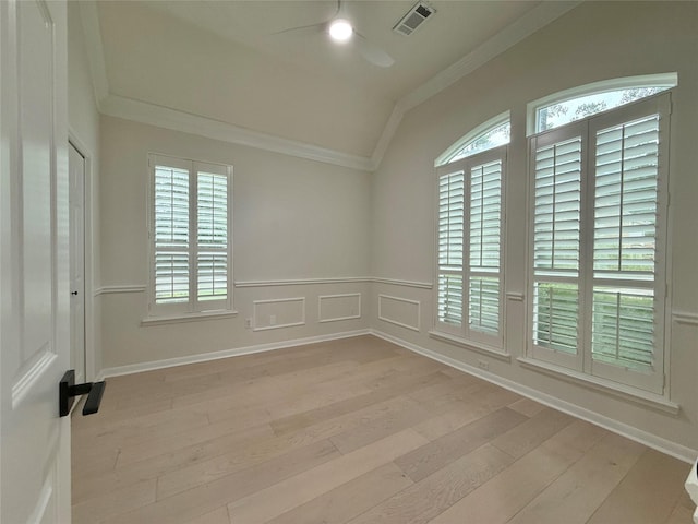 19 Pebble Hollow Ct, The Woodlands, TX 77381 - unfurnished room with vaulted ceiling, ceiling fan, ornamental molding, light wood finished floors, and a wainscoted wall