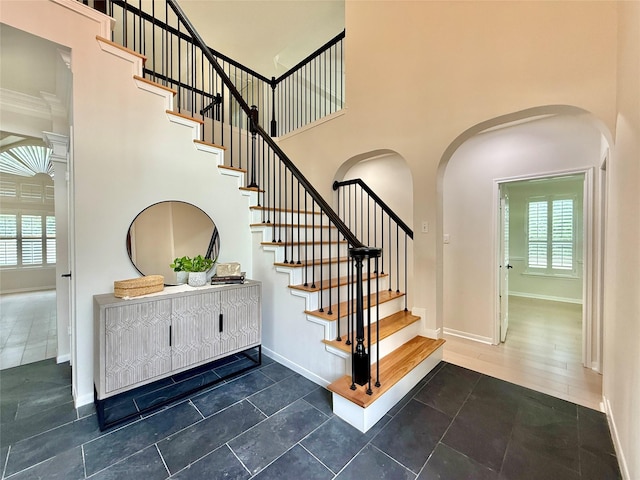 19 Pebble Hollow Ct, The Woodlands, TX 77381 - staircase with arched walkways and a high ceiling