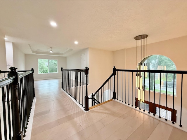 19 Pebble Hollow Ct, The Woodlands, TX 77381 - corridor with an upstairs landing, recessed lighting, and a raised ceiling