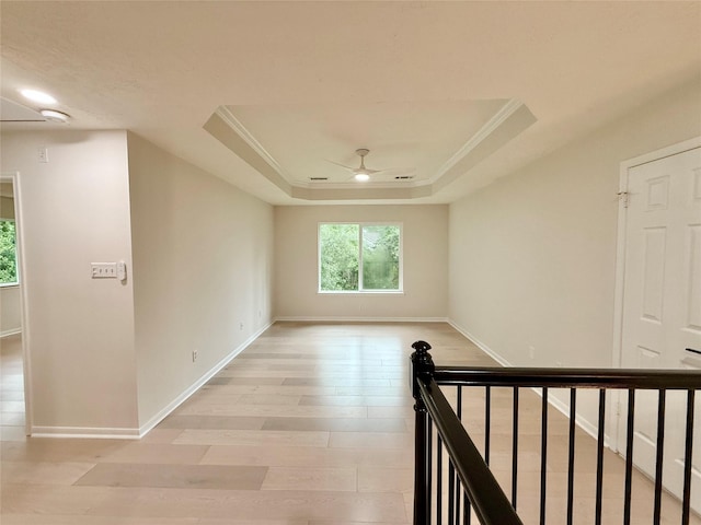19 Pebble Hollow Ct, The Woodlands, TX 77381 - empty room with ceiling fan, a tray ceiling, light wood-style floors, and crown molding