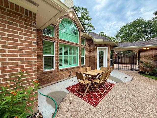 19 Pebble Hollow Ct, The Woodlands, TX 77381 - view of patio / terrace with outdoor dining area and a gate