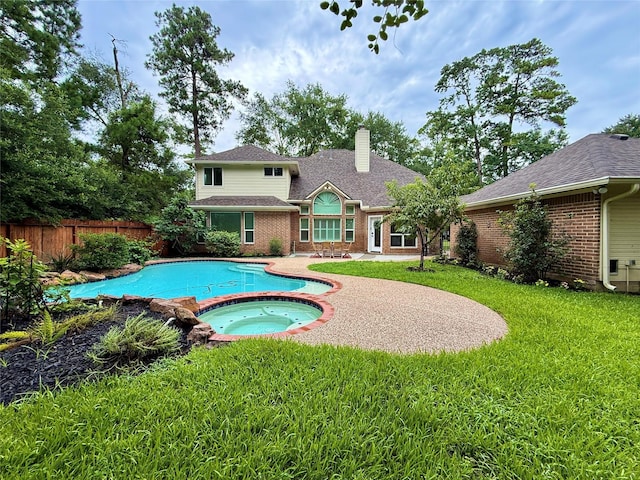 19 Pebble Hollow Ct, The Woodlands, TX 77381 - view of swimming pool with a pool with connected hot tub and a patio area