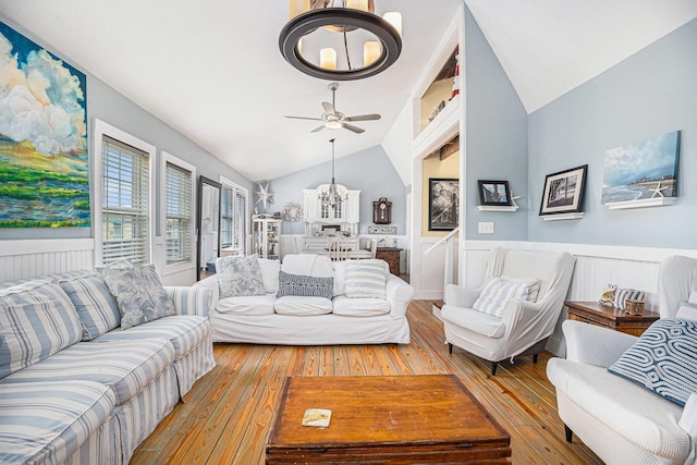16615 Mansvelt Rd, Jamaica Beach, TX 77554 - living room with wood-type flooring, vaulted ceiling, a wainscoted wall, a ceiling fan, and a chandelier