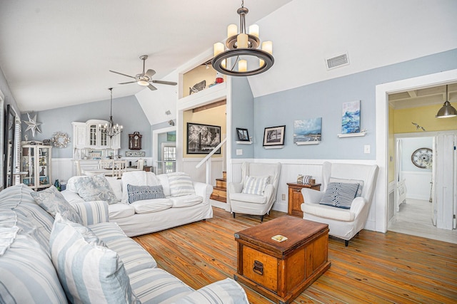 16615 Mansvelt Rd, Jamaica Beach, TX 77554 - living area with a chandelier, vaulted ceiling, a ceiling fan, a wainscoted wall, and hardwood / wood-style floors