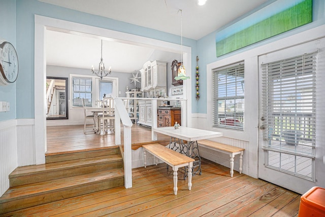 16615 Mansvelt Rd, Jamaica Beach, TX 77554 - dining space with light wood finished floors, wainscoting, and a chandelier