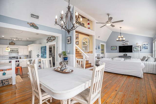 16615 Mansvelt Rd, Jamaica Beach, TX 77554 - dining room featuring wainscoting, a chandelier, hardwood / wood-style floors, ceiling fan, and lofted ceiling