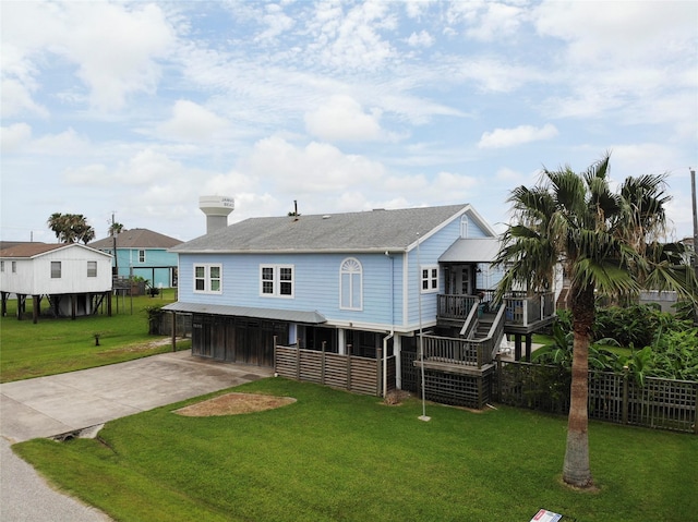 16615 Mansvelt Rd, Jamaica Beach, TX 77554 - rear view of house featuring concrete driveway, roof with shingles, and a chimney