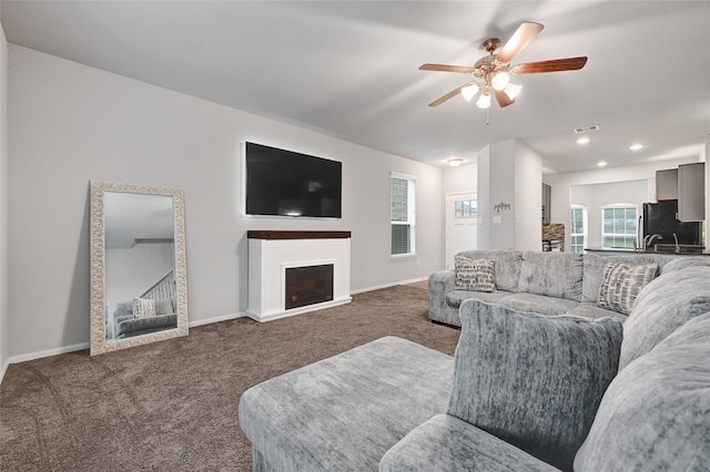 11346 Cascading Stream Way, Houston, TX 77044 - carpeted living area featuring ceiling fan, recessed lighting, and a fireplace