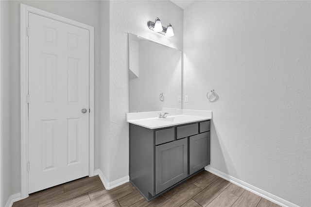 11346 Cascading Stream Way, Houston, TX 77044 - bathroom with wood tiled floors, vanity, and a textured wall