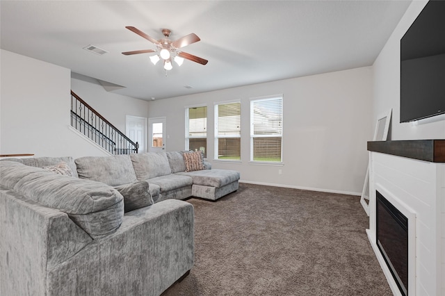 11346 Cascading Stream Way, Houston, TX 77044 - living area with ceiling fan, carpet, stairs, and a glass covered fireplace
