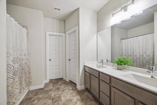 2322 Honey Heights Ln, Fresno, TX 77545 - bathroom featuring double vanity and stone finish flooring