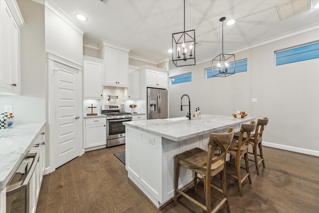 5240 Larkin St, Houston, TX 77007 - kitchen featuring appliances with stainless steel finishes, crown molding, light stone countertops, dark wood-style flooring, and white cabinetry