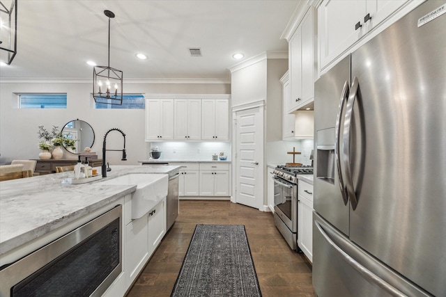 5240 Larkin St, Houston, TX 77007 - kitchen with stainless steel appliances, recessed lighting, tasteful backsplash, crown molding, and white cabinets