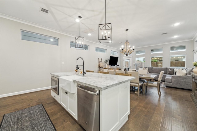 5240 Larkin St, Houston, TX 77007 - kitchen featuring dishwasher, a chandelier, open floor plan, ornamental molding, and white cabinets