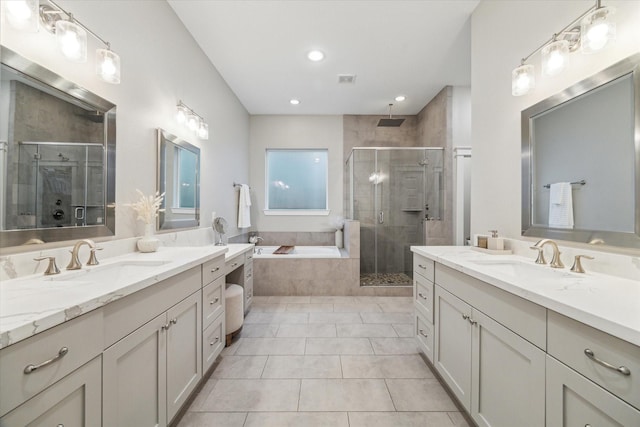 5240 Larkin St, Houston, TX 77007 - full bathroom featuring two vanities, a shower stall, tile patterned flooring, a bath, and recessed lighting