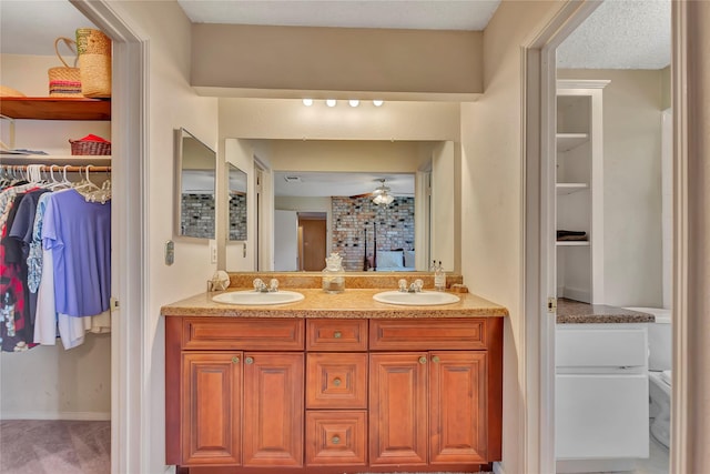 16426 Cavendish Dr, Houston, TX 77059 - bathroom with double vanity, a walk in closet, and a ceiling fan