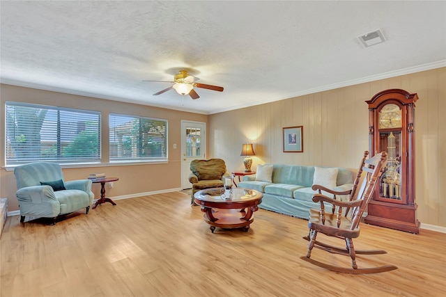 16426 Cavendish Dr, Houston, TX 77059 - living area with a ceiling fan, light wood-style floors, crown molding, and a textured ceiling
