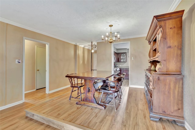 16426 Cavendish Dr, Houston, TX 77059 - dining area featuring light wood-type flooring, a chandelier, a textured ceiling, and crown molding