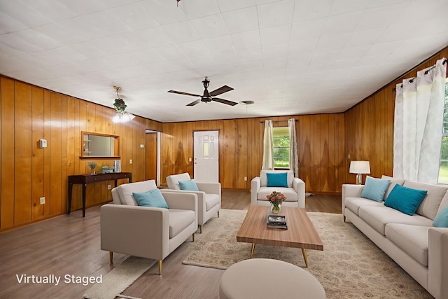 423 Pouland St, Zavalla, TX 75980 - living room featuring wood finished floors, wood walls, and ceiling fan