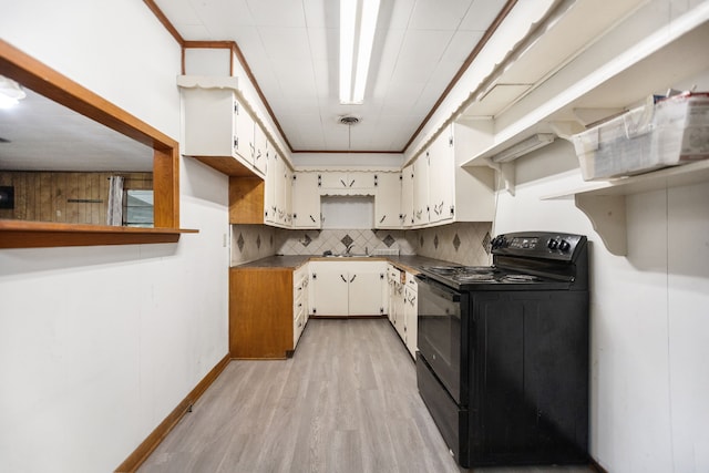 423 Pouland St, Zavalla, TX 75980 - kitchen with electric range, light wood-style floors, and decorative backsplash