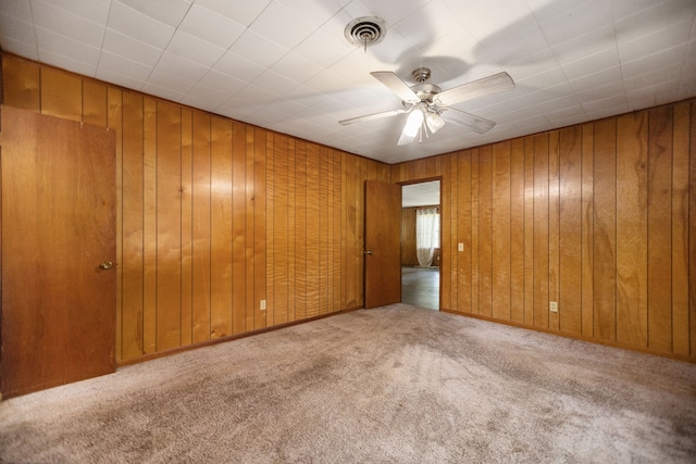 423 Pouland St, Zavalla, TX 75980 - unfurnished room with carpet flooring, ceiling fan, and wood walls
