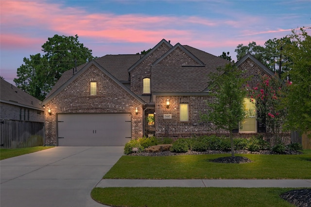 3447 Warwick River Trl, Kingwood, TX 77365 - french country home with brick siding, concrete driveway, roof with shingles, and an attached garage