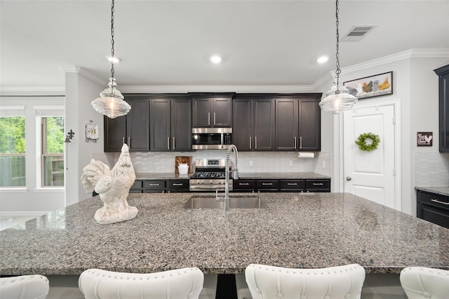 3447 Warwick River Trl, Kingwood, TX 77365 - kitchen with appliances with stainless steel finishes, tasteful backsplash, a breakfast bar area, dark brown cabinetry, and ornamental molding